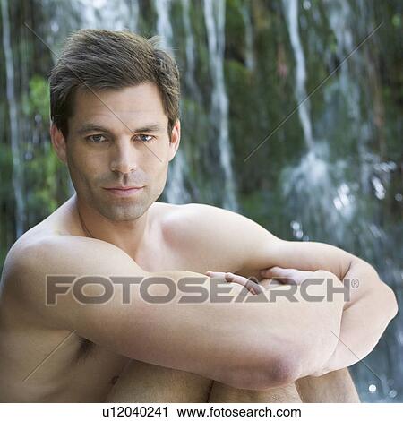 A man sitting by a waterfall View Large Photo Image Stock Image - A man sitting by a waterfall. Fotosearch