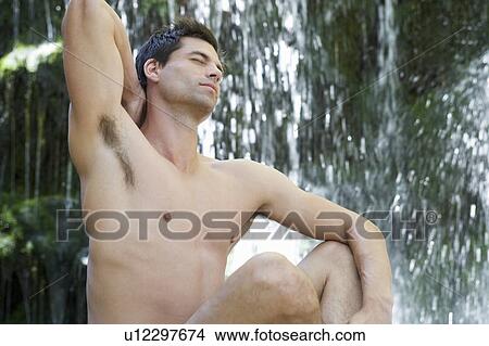 A man stretching by a waterfall View Large Photo Image Picture - A man stretching by a waterfall. Fotosearch