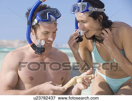 Stock Photo - A couple snorkeling. Fotosearch