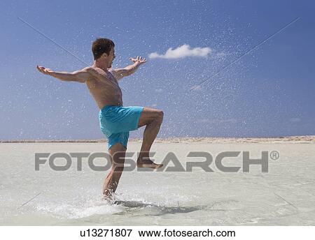A man splashing in the sea View Large Photo Image Stock Photo - A man splashing in the sea. Fotosearch