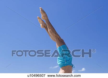A man standing on his hands View Large Photo Image Stock Photo - A man standing on his hands. Fotosearch