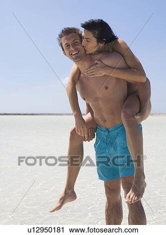 A romantic couple walking on a beach View Large Photo Image Stock Image - A romantic couple walking on a beach. Fotosearch