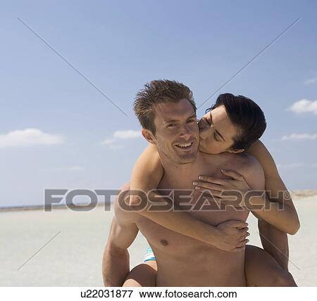 A romantic couple walking on a beach View Large Photo Image Stock Photo - A romantic couple walking on a beach. Fotosearch