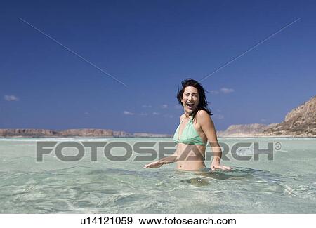 A woman wading in the sea View Large Photo Image Stock Photo - A woman wading in the sea. Fotosearch