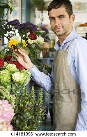 Male florist amongst the flowers in his shop View Large Photo Image Stock Photograph - Male florist amongst the flowers in his shop. Fotosearch