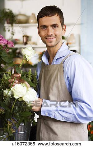 Male florist amongst the flowers in his shop View Large Photo Image Stock Photography - Male florist amongst the flowers in his shop. Fotosearch