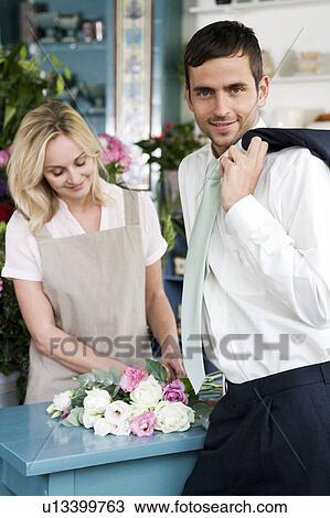 Man buying a bouquet of flowers in a florist's shop View Large Photo Image Stock Image - Man buying a bouquet of flowers in a florist's shop. Fotosearch