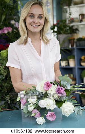 Woman florist creating a bouquet of pink and white roses View Large Photo Image Stock Image - Woman florist creating a bouquet of pink and white roses. Fotosearch