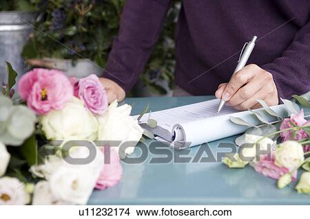 Woman florist taking an order over the telephone View Large Photo Image Picture - Woman florist taking an order over the telephone. Fotosearch