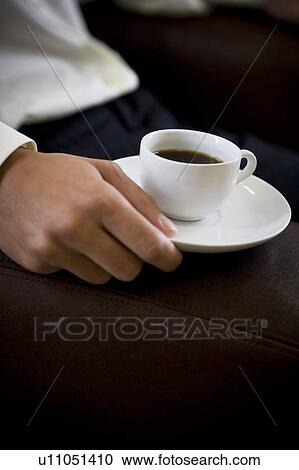 Close up of a man holding an espresso cup View Large Photo Image Stock Image - Close up of a man holding an espresso cup. Fotosearch