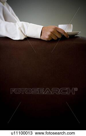 Close up of a man holding an espresso cup View Large Photo Image Stock Image - Close up of a man holding an espresso cup. Fotosearch