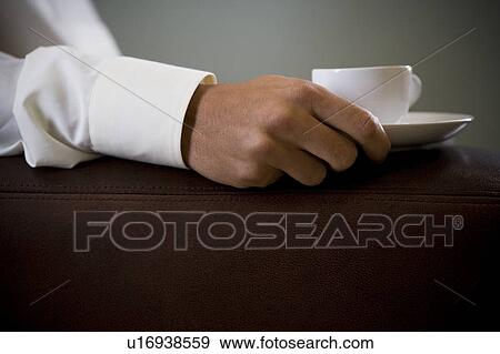 Close up of a man holding an espresso cup View Large Photo Image Stock Photo - Close up of a man holding an espresso cup. Fotosearch