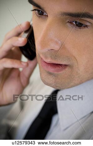 Portrait of a businessman using a mobile phone View Large Photo Image Stock Image - Portrait of a businessman using a mobile phone. Fotosearch