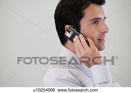 Portrait of a businessman using a mobile phone View Large Photo Image Stock Photograph - Portrait of a businessman using a mobile phone. Fotosearch