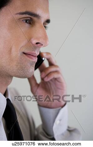 Portrait of a businessman using a mobile phone View Large Photo Image Stock Photograph - Portrait of a businessman using a mobile phone. Fotosearch