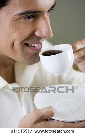 Portrait of a man drinking from an espresso cup View Large Photo Image Stock Photo - Portrait of a man drinking from an espresso cup. Fotosearch