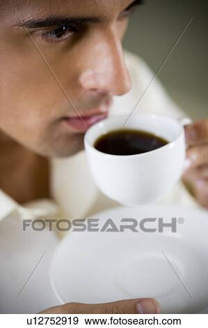 Portrait of a man drinking from an espresso cup View Large Photo Image Stock Photo - Portrait of a man drinking from an espresso cup. Fotosearch