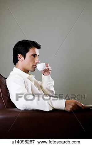 Portrait of a man drinking from an espresso cup View Large Photo Image Stock Photo - Portrait of a man drinking from an espresso cup. Fotosearch