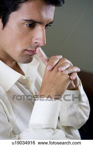 Portrait of a man looking thoughtful and pensive and worried View Large Photo Image Stock Photograph - Portrait of a man looking thoughtful and pensive and worried. Fotosearch