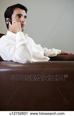 Stock Image - Portrait of a man using a cellphone. Fotosearch