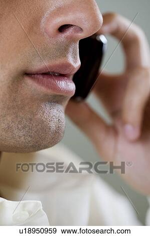 Portrait of a man using a cellphone View Large Photo Image Stock Photo - Portrait of a man using a cellphone. Fotosearch