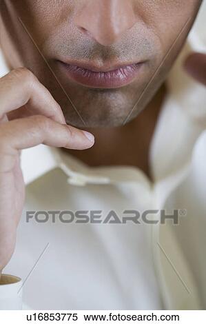 Stock Photography - Portrait of a man with a headache looking stressed, close up . Fotosearch