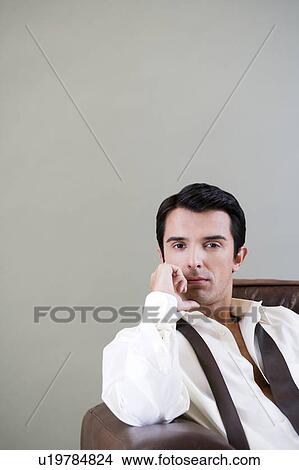 Portrait of a young man looking pensive View Large Photo Image Picture - Portrait of a young man looking pensive. Fotosearch