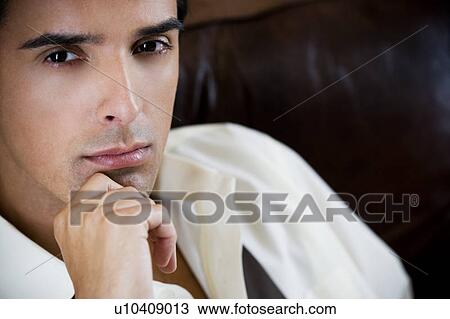 Portrait of a young man looking pensive View Large Photo Image Stock Image - Portrait of a young man looking pensive. Fotosearch