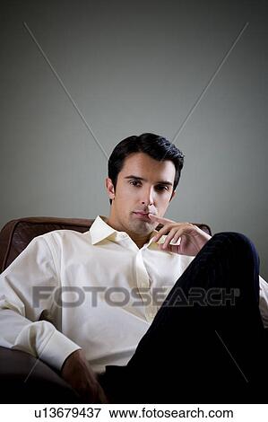 Portrait of a young man looking pensive View Large Photo Image Stock Photo - Portrait of a young man looking pensive. Fotosearch