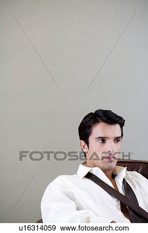 Portrait of a young man looking pensive View Large Photo Image Stock Photo - Portrait of a young man looking pensive. Fotosearch