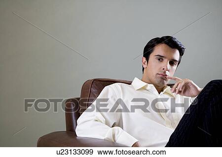 Stock Photo - Portrait of a young man looking pensive. Fotosearch