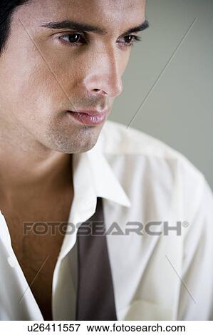 Portrait of a young man looking pensive View Large Photo Image Stock Photo - Portrait of a young man looking pensive. Fotosearch