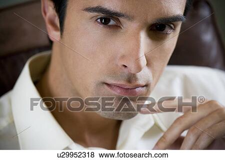 Portrait of a young man looking pensive View Large Photo Image Stock Photo - Portrait of a young man looking pensive. Fotosearch