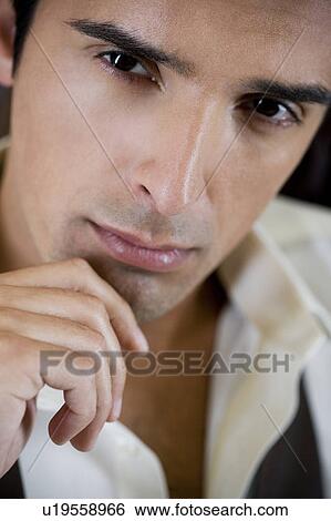 Portrait of a young man looking pensive View Large Photo Image Stock Photograph - Portrait of a young man looking pensive. Fotosearch