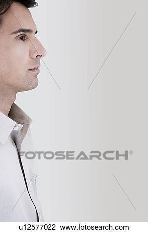 Stock Image - Side profile portrait of a businessman in casual dress. Fotosearch