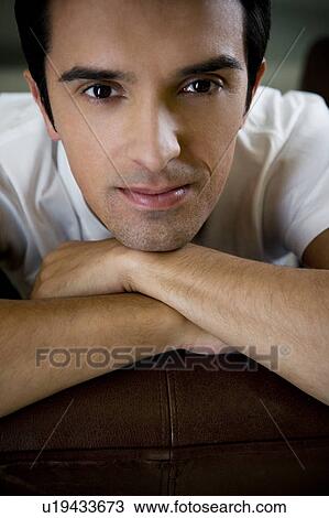 Stock Image - Portrait of a man relaxing at home. Fotosearch