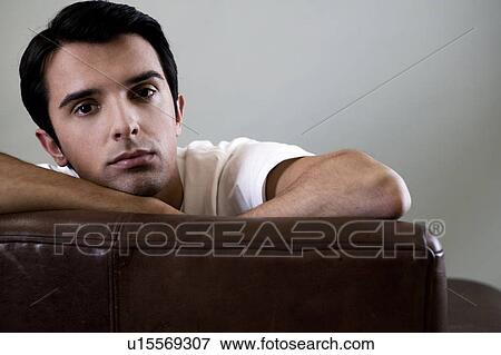 Portrait of a man relaxing in an armchair View Large Photo Image Stock Photo - Portrait of a man relaxing in an armchair. Fotosearch