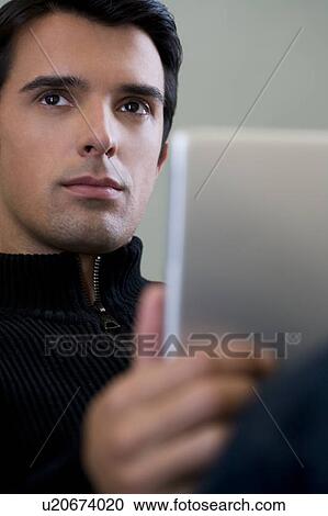 Portrait of a man using a laptop computer View Large Photo Image Stock Image - Portrait of a man using a laptop computer. Fotosearch