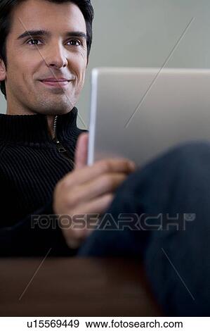 Portrait of a man using a laptop computer View Large Photo Image Stock Photo - Portrait of a man using a laptop computer. Fotosearch