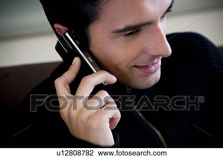 Stock Image - Portrait of a man using a mobile phone. Fotosearch