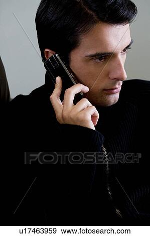 Portrait of a man using a mobile phone View Large Photo Image Stock Photo - Portrait of a man using a mobile phone. Fotosearch