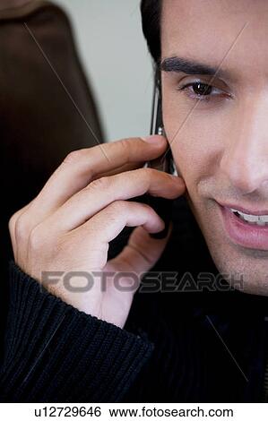 Portrait of a man using a mobile phone View Large Photo Image Stock Photograph - Portrait of a man using a mobile phone. Fotosearch