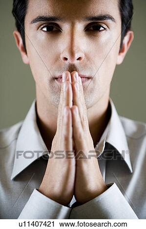 Portrait of a man with his hands in a praying position View Large Photo Image Stock Image - Portrait of a man with his hands in a praying position . Fotosearch