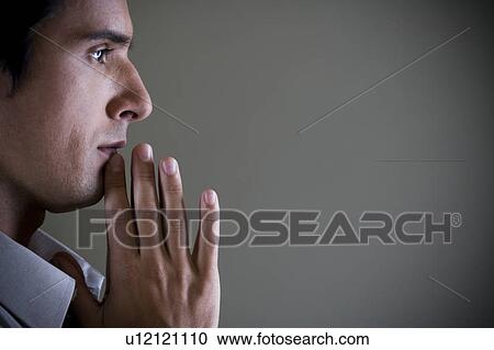 Portrait of a man with his hands in a praying position View Large Photo Image Stock Image - Portrait of a man with his hands in a praying position . Fotosearch