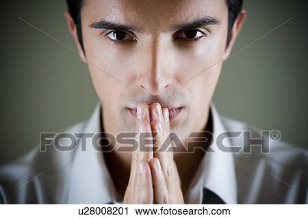 Portrait of a man with his hands in a praying position View Large Photo Image Stock Image - Portrait of a man with his hands in a praying position . Fotosearch