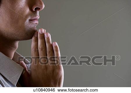 Portrait of a man with his hands in a praying position View Large Photo Image Stock Photograph - Portrait of a man with his hands in a praying position . Fotosearch
