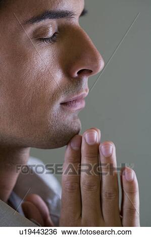 Portrait of a man with his hands in a praying position View Large Photo Image Stock Photograph - Portrait of a man with his hands in a praying position . Fotosearch