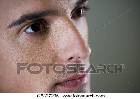 Portrait of a young man looking pensive View Large Photo Image Stock Photograph - Portrait of a young man looking pensive. Fotosearch