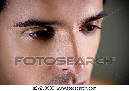 Portrait of a young man looking pensive, close up of eyes, View Large Photo Image Stock Image - Portrait of a young man looking pensive, close up of eyes, . Fotosearch