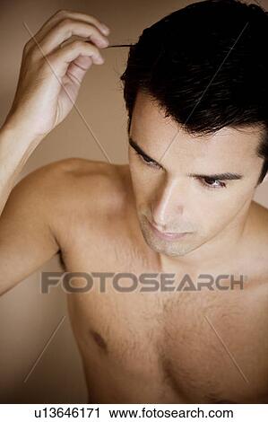 Portrait of a young man running his fingers through his hair View Large Photo Image Stock Image - Portrait of a young man running his fingers through his hair. Fotosearch